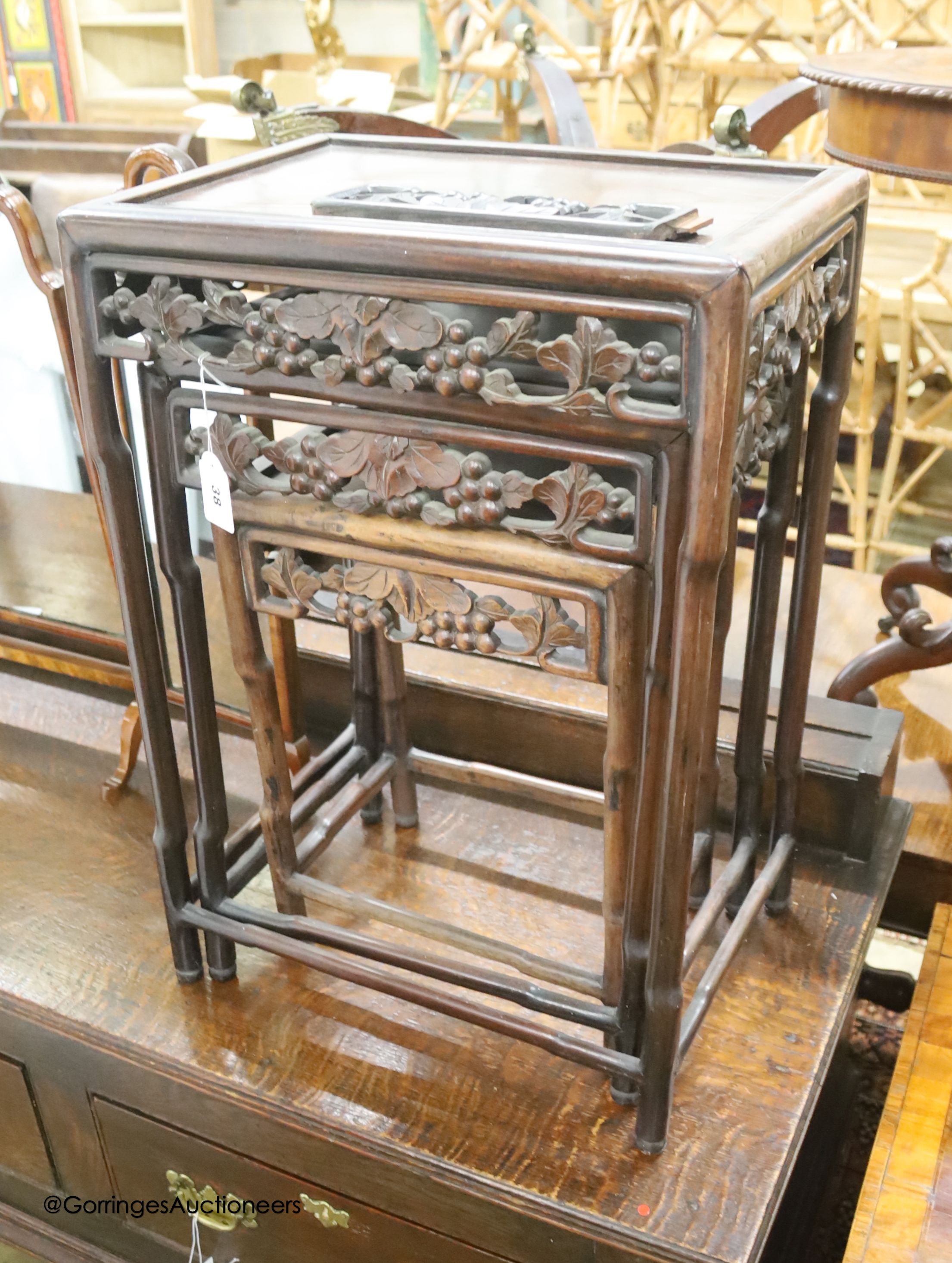 A nest of three Chinese rectangular carved hardwood tables, width 45cm, depth 33cm, height 54cm